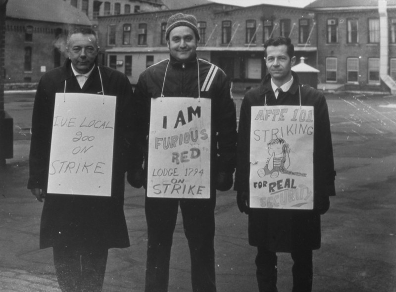 Three Men who are a Part of the Sprague Strike Wear Signs from the Different Unions They Represent