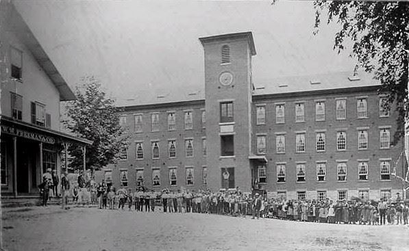 The Eagle Mill in 1872 with its workers lined up in front.